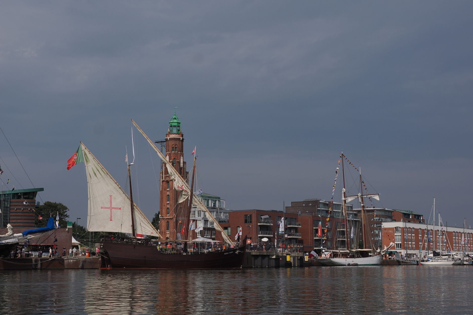 Historic sailing ship in a harbour, evoking the USS Wateree swept inland by the 1868 tsunami