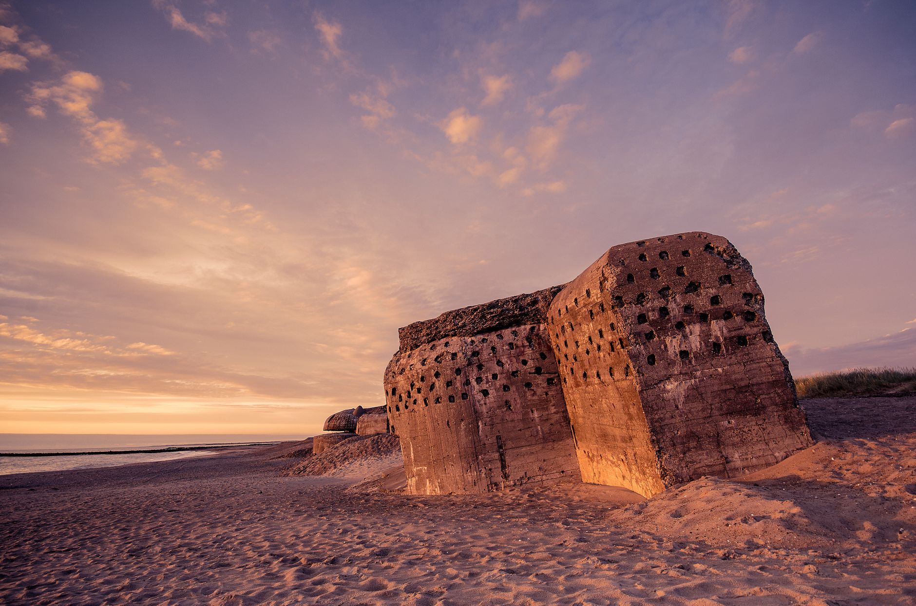 Ancient fortress ruins among sand dunes, similar to the historic Arg-e Bam citadel in Iran