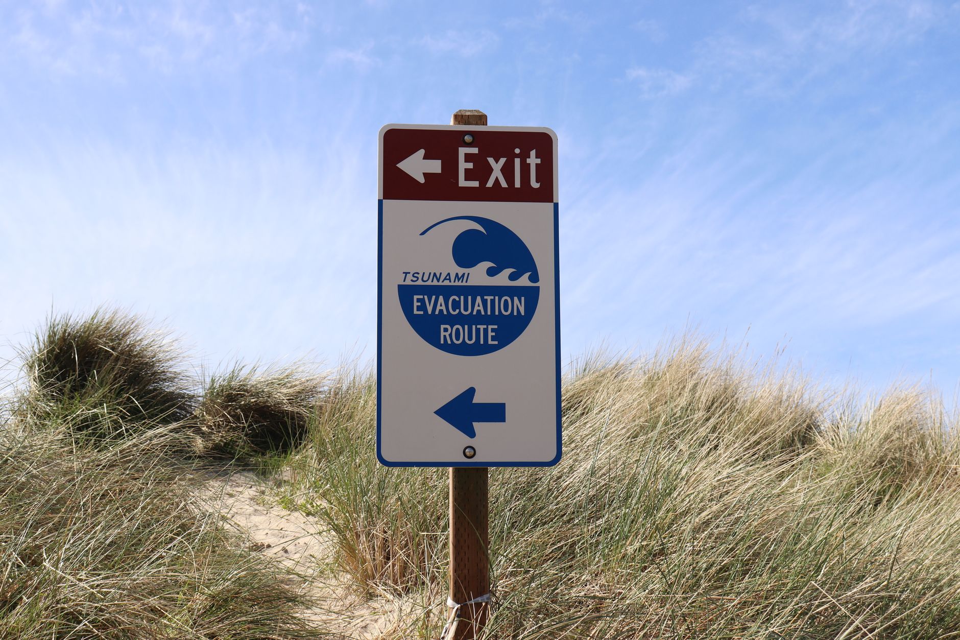 Tsunami warning sign on a coastline vulnerable to earthquake-triggered waves