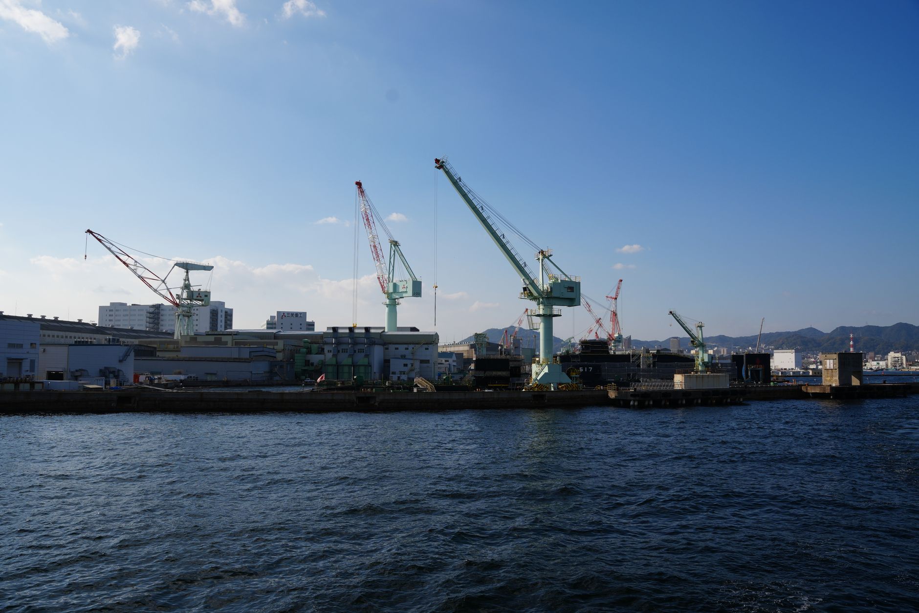 Japanese port with cranes, similar to Kobe's busy harbour before the 1995 earthquake